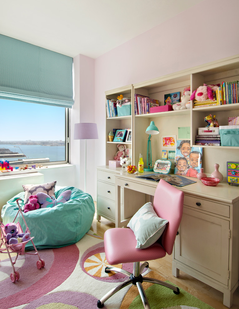 Photo of a small traditional kids' bedroom for girls and kids 4-10 years old in Miami with pink walls and medium hardwood floors.