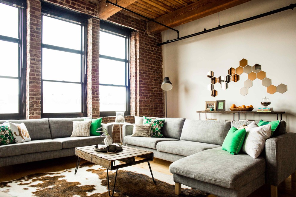 Inspiration for an industrial open concept living room in Other with white walls.