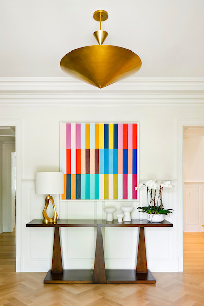 Inspiration for a large transitional medium tone wood floor, brown floor and wall paneling foyer remodel in Baltimore with white walls