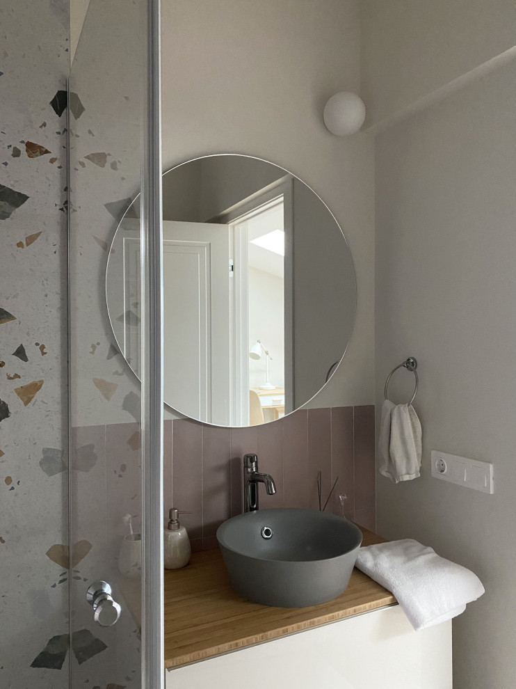 This is an example of a medium sized traditional shower room bathroom in Moscow with flat-panel cabinets, white cabinets, a corner shower, a wall mounted toilet, multi-coloured tiles, ceramic tiles, beige walls, porcelain flooring, a built-in sink, pink floors, a single sink and a floating vanity unit.