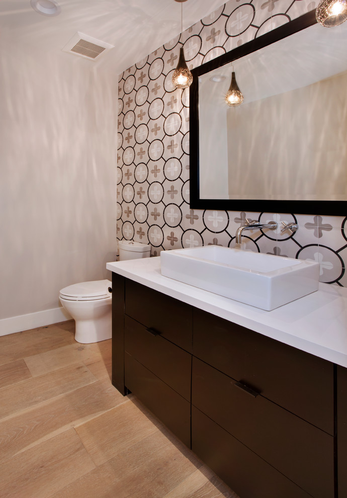 Design ideas for a mid-sized contemporary 3/4 bathroom in Orange County with flat-panel cabinets, dark wood cabinets, a one-piece toilet, white tile, glass tile, beige walls, light hardwood floors, a vessel sink and engineered quartz benchtops.