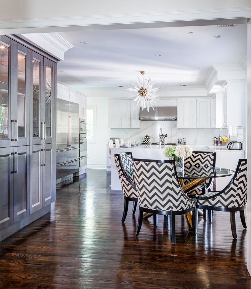 Example of a large transitional galley dark wood floor and brown floor open concept kitchen design in New York with a drop-in sink, shaker cabinets, white cabinets, quartzite countertops, white backsplash, stone slab backsplash, stainless steel appliances and an island