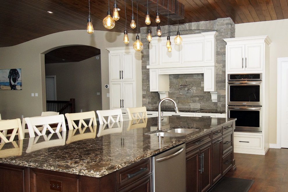 Inspiration for a large rustic galley kitchen remodel with an undermount sink, recessed-panel cabinets, white cabinets, quartzite countertops, stainless steel appliances and brown countertops