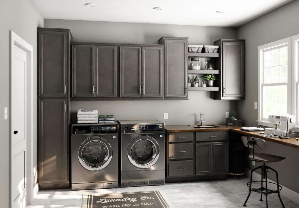 Photo of a traditional laundry room in Other with flat-panel cabinets, medium wood cabinets and a side-by-side washer and dryer.