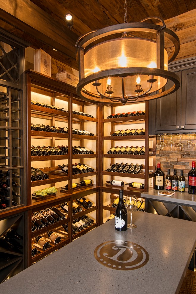 This is an example of a mid-sized transitional wine cellar in New York with ceramic floors, display racks and grey floor.