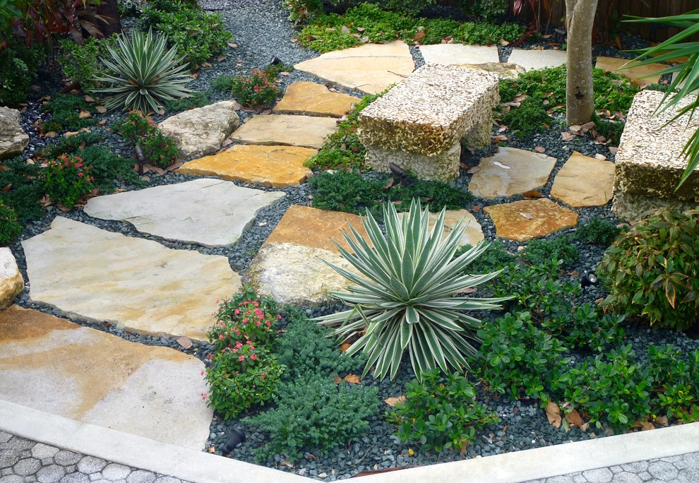 Photo of a mid-sized transitional full sun backyard gravel garden path in Miami.