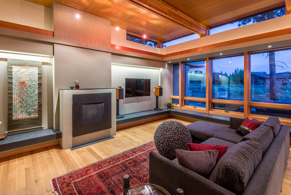 Inspiration for a mid-sized contemporary formal and open concept medium tone wood floor living room remodel in Other with beige walls, a standard fireplace, a wall-mounted tv and a metal fireplace