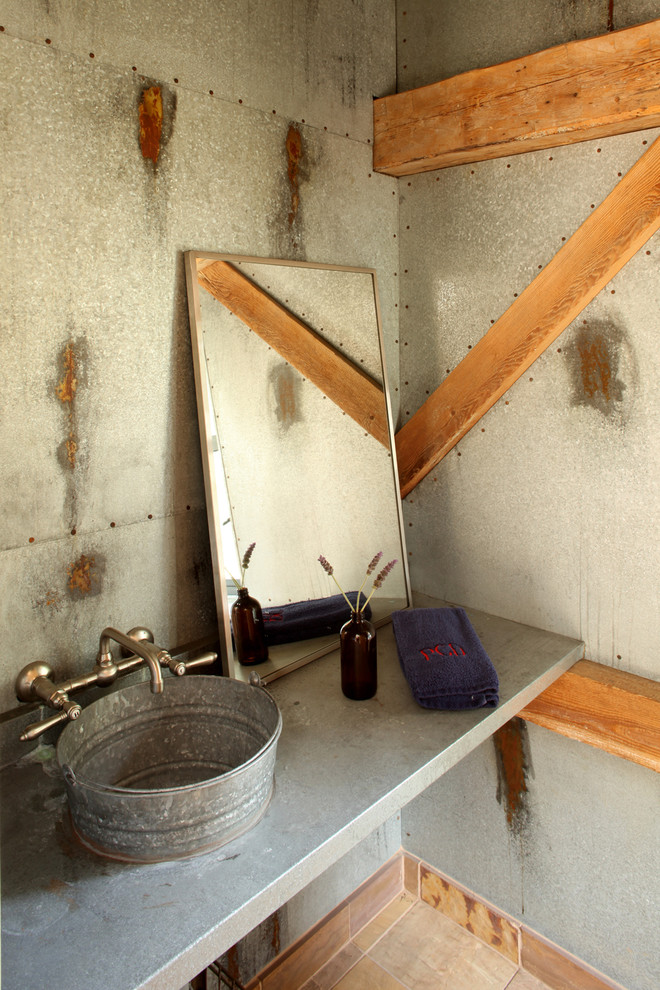 Inspiration for an industrial powder room in Santa Barbara with a vessel sink.