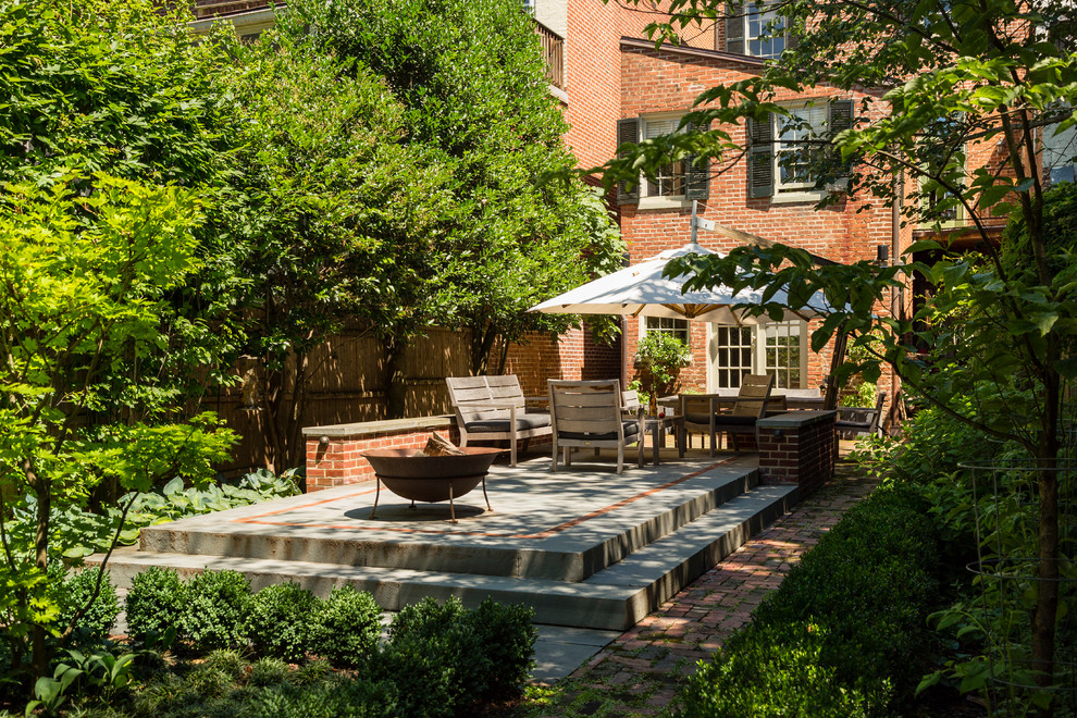 Small trendy backyard brick patio photo in DC Metro with a fire pit and no cover
