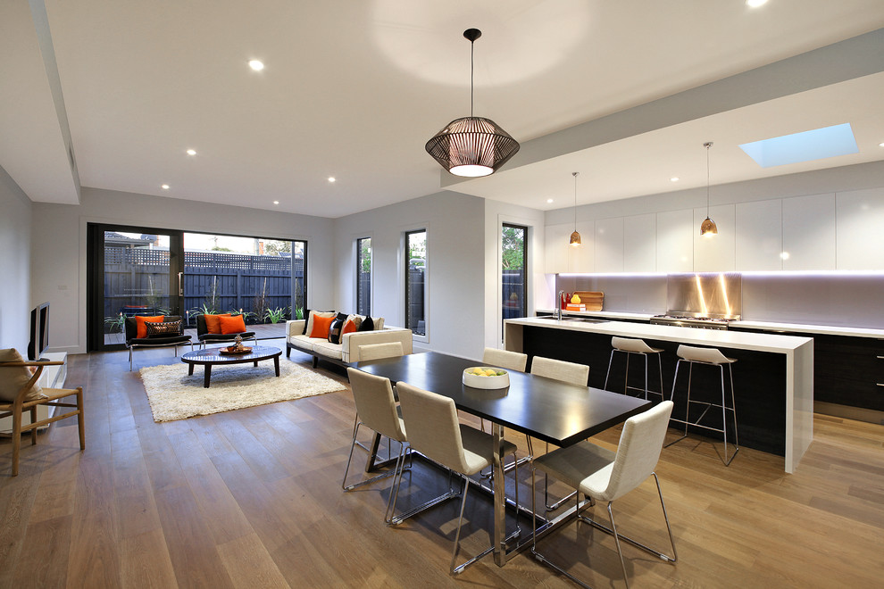 Inspiration for a large contemporary open plan dining in Melbourne with white walls and medium hardwood floors.