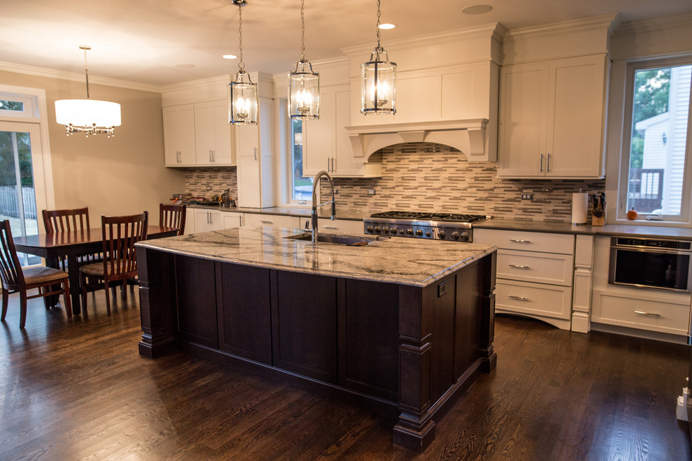 Eat-in kitchen - large transitional single-wall dark wood floor eat-in kitchen idea in Chicago with an undermount sink, shaker cabinets, white cabinets, marble countertops, multicolored backsplash, matchstick tile backsplash, stainless steel appliances and an island