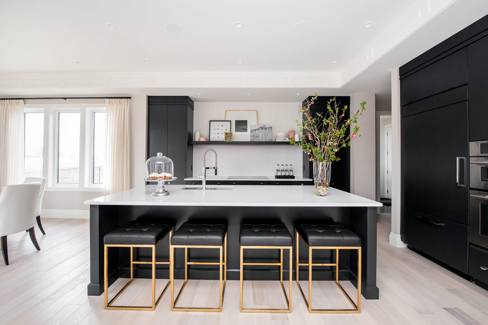 Inspiration for a transitional eat-in kitchen in Other with an undermount sink, flat-panel cabinets, white splashback, panelled appliances, light hardwood floors and with island.