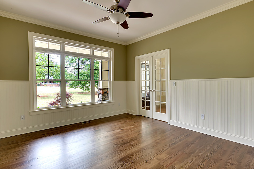 Enclosed dining room - transitional dark wood floor enclosed dining room idea with green walls and no fireplace