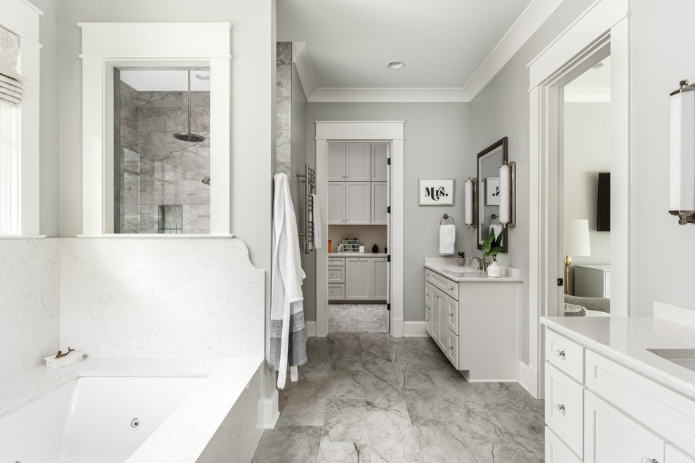 Inspiration for a medium sized traditional ensuite bathroom in Nashville with shaker cabinets, white cabinets, a submerged bath, a built-in shower, a one-piece toilet, grey tiles, grey walls, porcelain flooring, a submerged sink, engineered stone worktops, an open shower, white worktops, a wall niche, double sinks and a built in vanity unit.