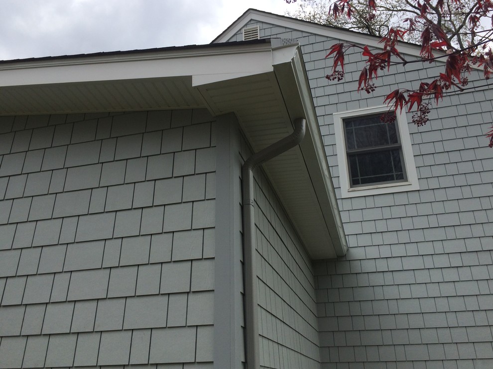 Photo of a mid-sized traditional two-storey grey exterior in New York with concrete fiberboard siding.
