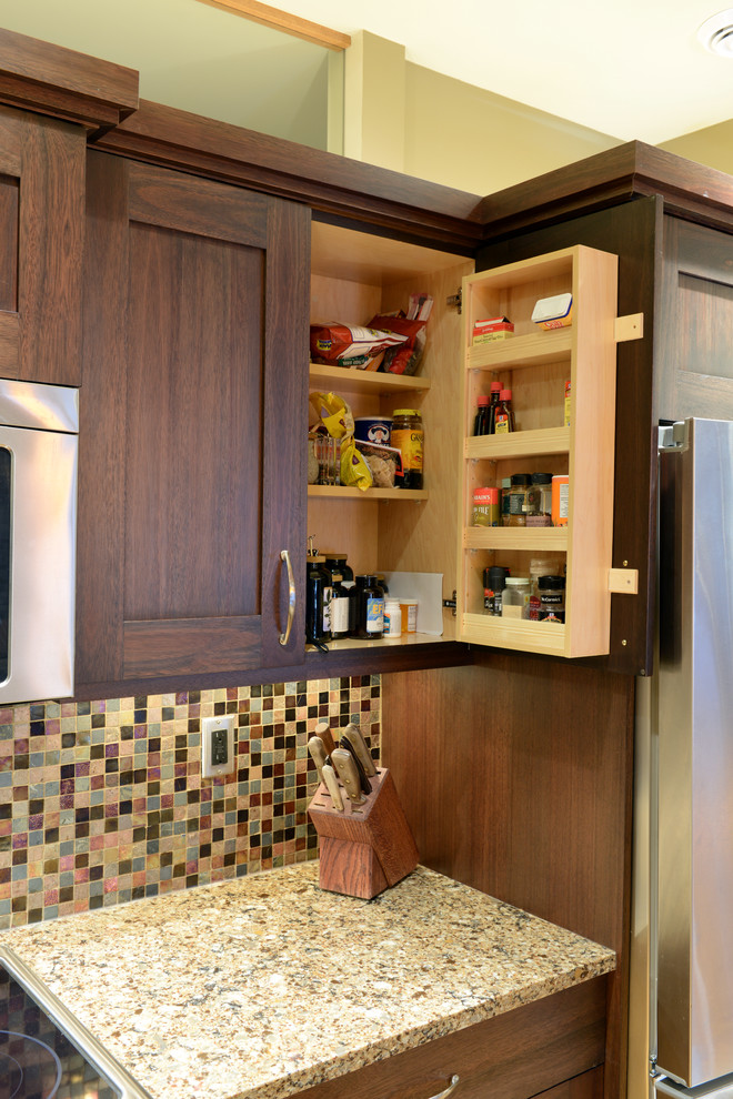 Open concept kitchen - mid-sized transitional l-shaped light wood floor open concept kitchen idea with an undermount sink, shaker cabinets, dark wood cabinets, quartzite countertops, multicolored backsplash, mosaic tile backsplash, stainless steel appliances and an island