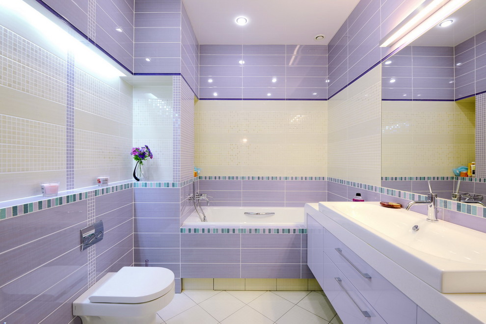 This is an example of a mid-sized contemporary master bathroom in Novosibirsk with flat-panel cabinets, purple cabinets, an alcove tub, a shower/bathtub combo, a wall-mount toilet, multi-coloured tile, ceramic tile, multi-coloured walls, porcelain floors, a drop-in sink, solid surface benchtops, white floor and an open shower.