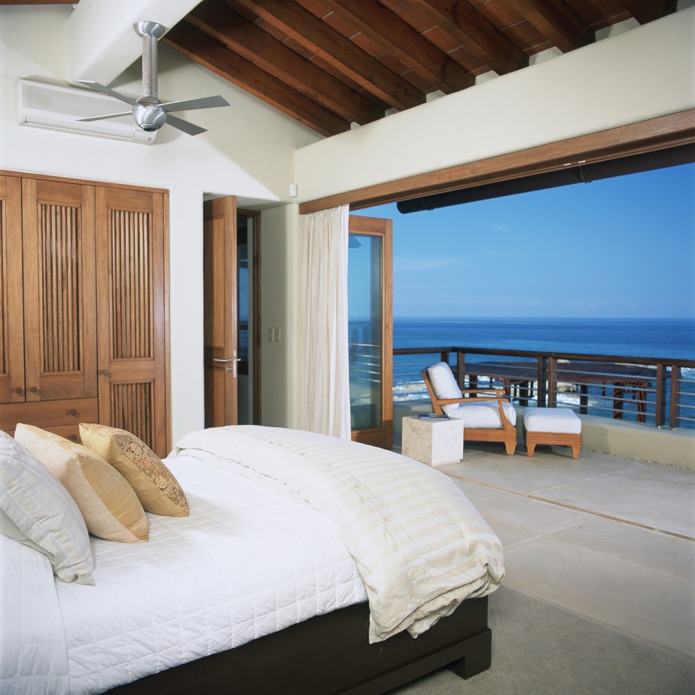 Design ideas for an expansive tropical guest bedroom in Other with white walls and no fireplace.