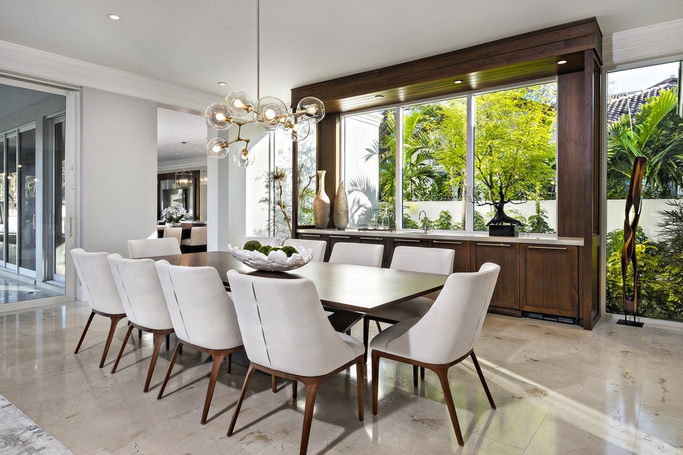 Photo of a contemporary dining room in Miami with marble floors, grey walls and beige floor.