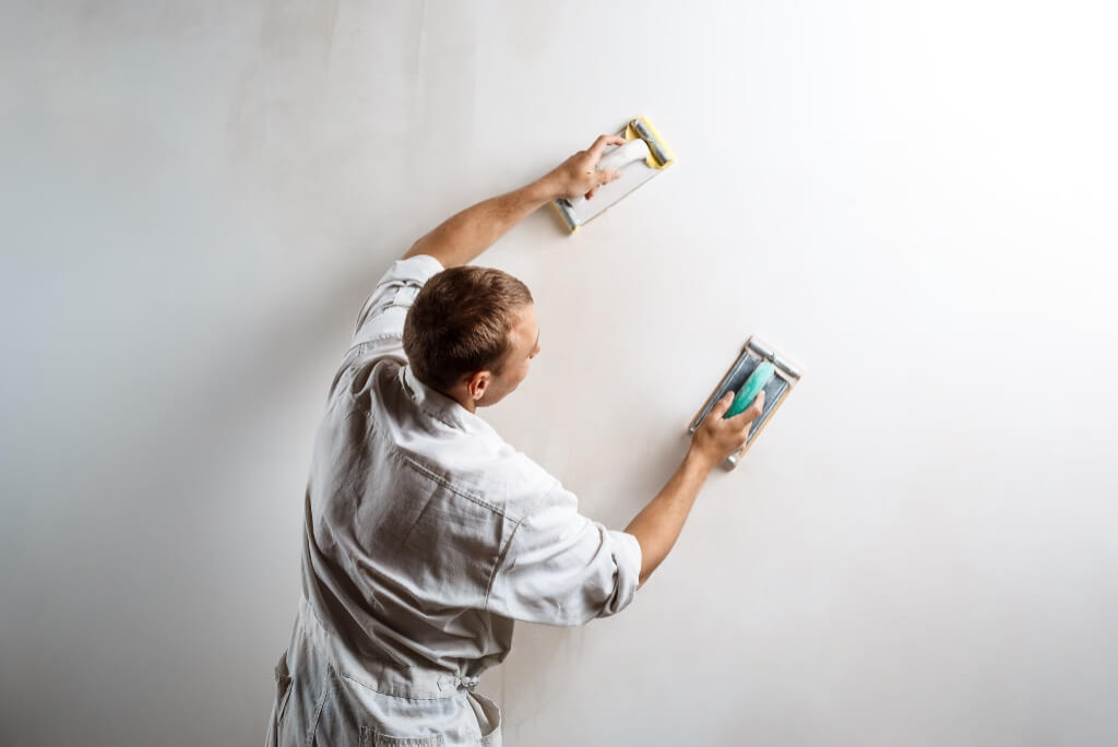 guy doing prep work for wall