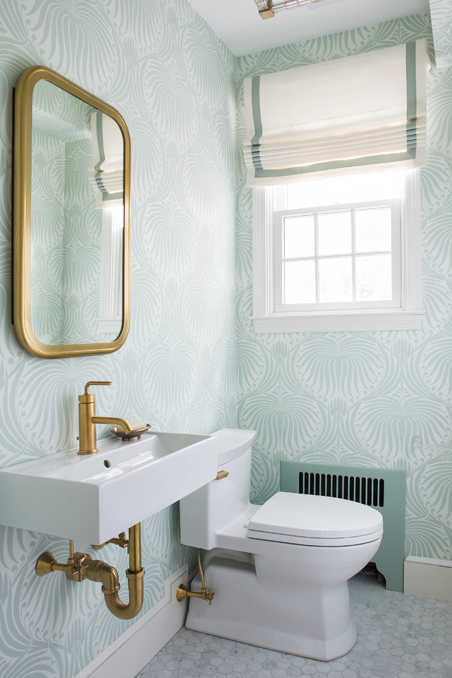 Inspiration for a small transitional powder room in Boston with blue walls, a trough sink, solid surface benchtops, shaker cabinets, white cabinets, a wall-mount toilet, white tile, stone tile, mosaic tile floors and white floor.