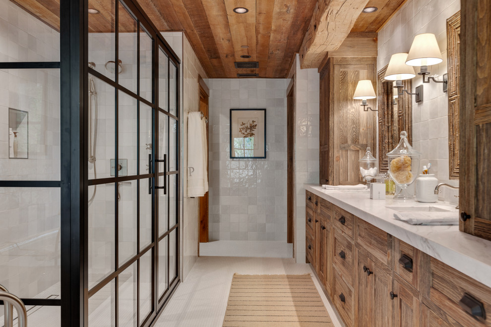 Photo of a country master bathroom in Other with an undermount sink, a double vanity, a built-in vanity, wood, an alcove shower, gray tile, white tile, marble benchtops, white floor, a hinged shower door and multi-coloured benchtops.