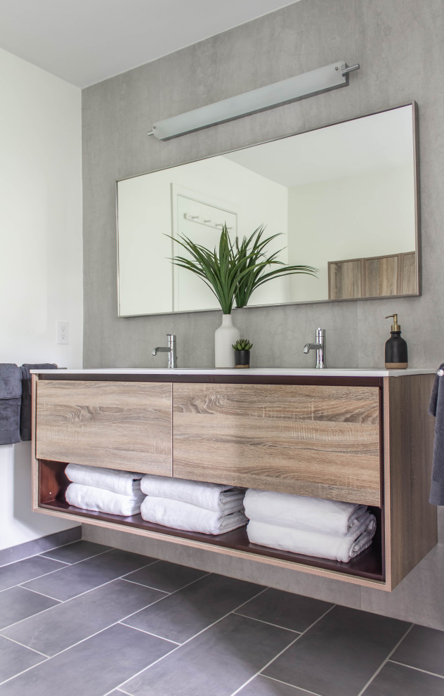 Inspiration for a contemporary bathroom in Nashville with flat-panel cabinets, medium wood cabinets, gray tile, white walls, grey floor and white benchtops.