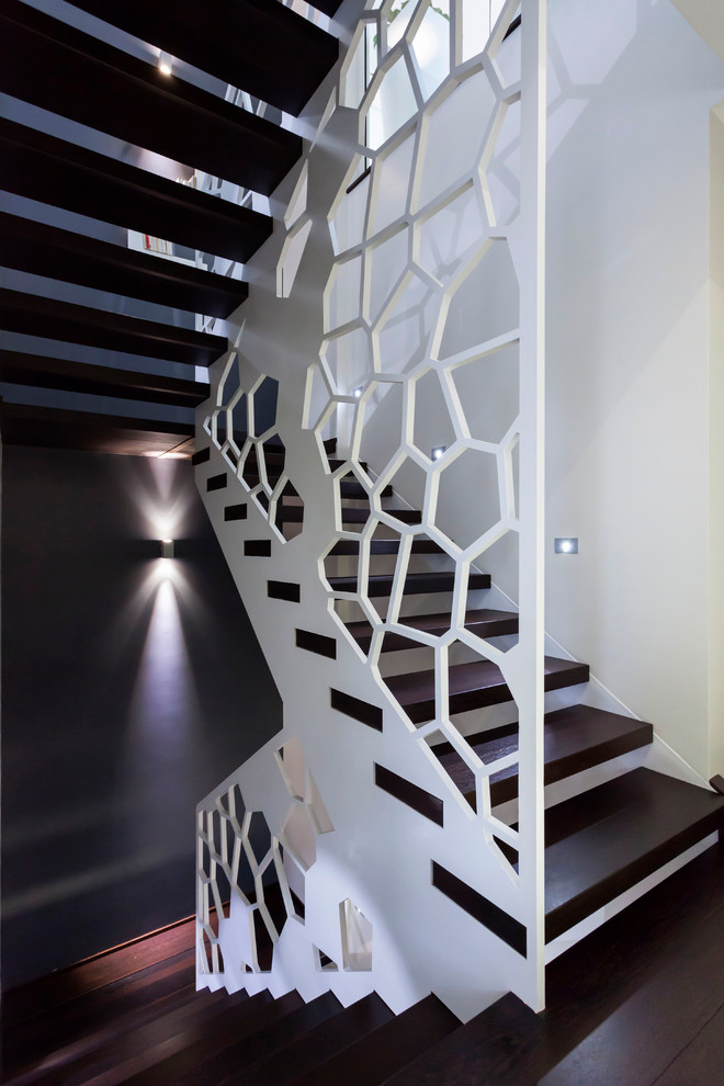 Design ideas for a large contemporary wood u-shaped staircase in Nancy with open risers.