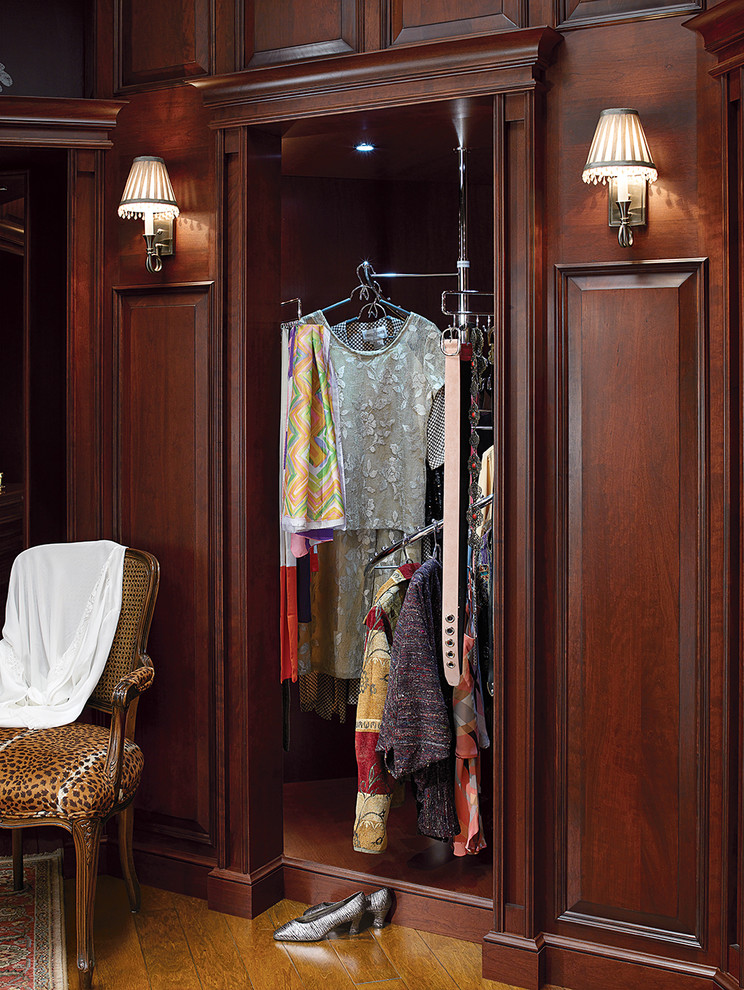 This is an example of a traditional storage and wardrobe in Other with dark wood cabinets.