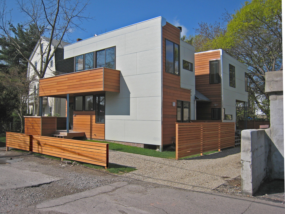 Photo of a large contemporary two-storey grey exterior in Boston with mixed siding.