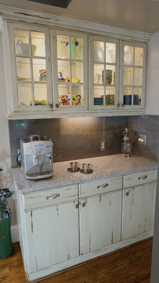 Example of a large mountain style u-shaped medium tone wood floor eat-in kitchen design in Atlanta with an undermount sink, flat-panel cabinets, distressed cabinets, quartz countertops, white backsplash, ceramic backsplash, stainless steel appliances and beige walls