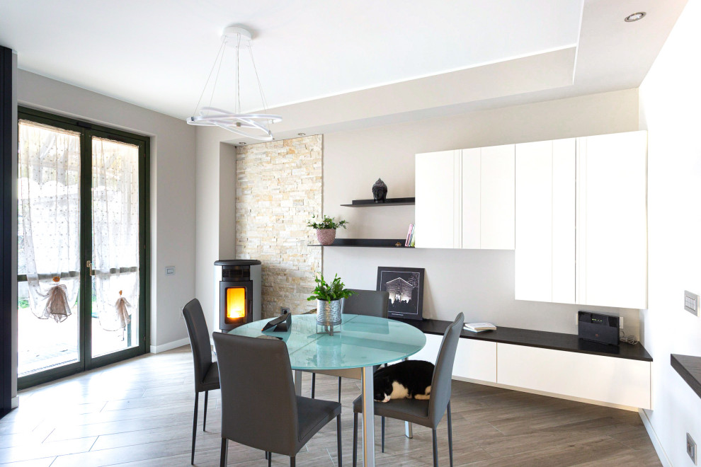 This is an example of a modern open plan dining in Other with beige walls, porcelain floors and brick walls.