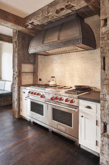 Eat-in kitchen - mid-sized rustic u-shaped dark wood floor and brown floor eat-in kitchen idea with a farmhouse sink, recessed-panel cabinets, white cabinets, quartz countertops, paneled appliances, an island and gray countertops