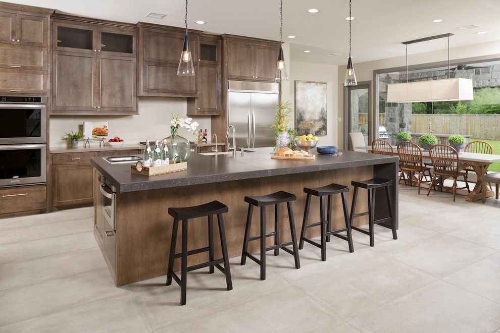 Eat-in kitchen - transitional l-shaped ceramic tile eat-in kitchen idea in Houston with flat-panel cabinets, gray cabinets, stainless steel appliances, an island, a farmhouse sink and quartz countertops