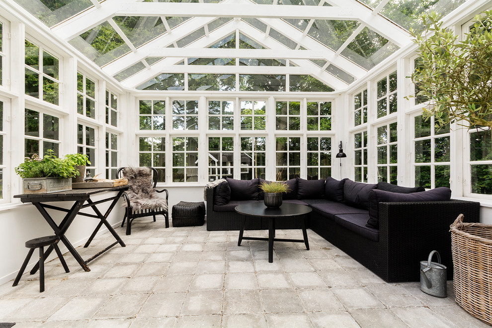 Design ideas for a large scandinavian sunroom with concrete floors, a glass ceiling and grey floor.