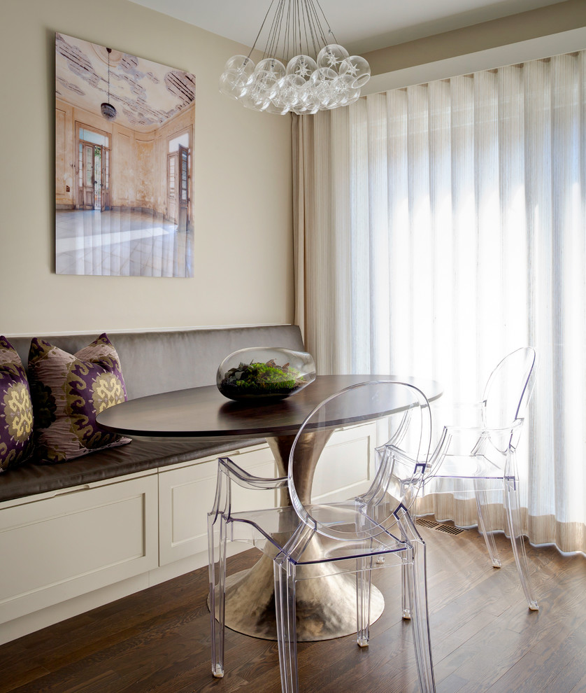 This is an example of a transitional dining room in Chicago with beige walls and dark hardwood floors.