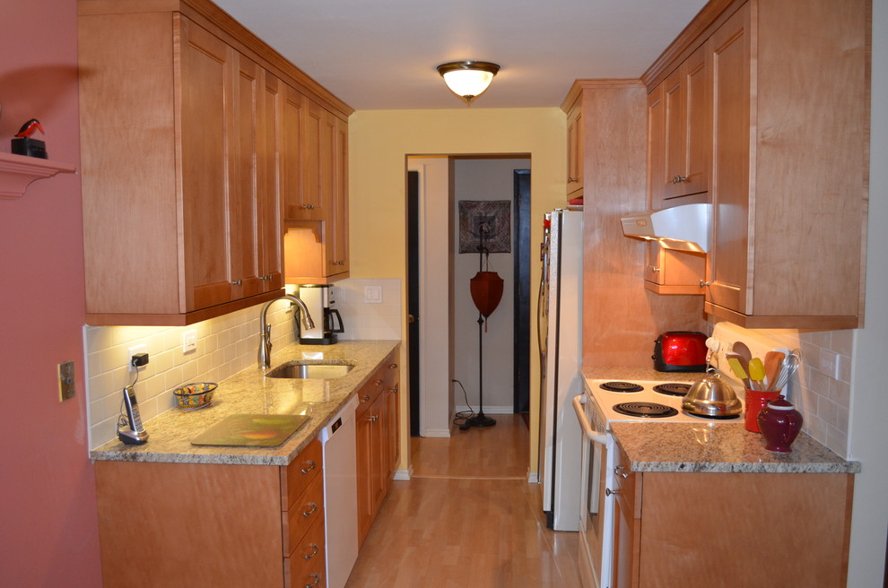 Small transitional galley light wood floor eat-in kitchen photo in Seattle with an undermount sink, shaker cabinets, medium tone wood cabinets, granite countertops, white backsplash, subway tile backsplash and white appliances