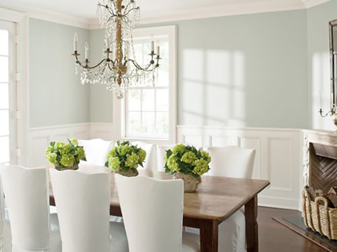 This is an example of a large traditional open plan dining in Charlotte with green walls and dark hardwood floors.