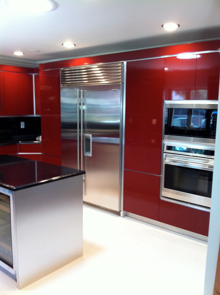 This is an example of a mid-sized modern l-shaped eat-in kitchen in New York with flat-panel cabinets, red cabinets, solid surface benchtops, stainless steel appliances, porcelain floors, with island and beige floor.