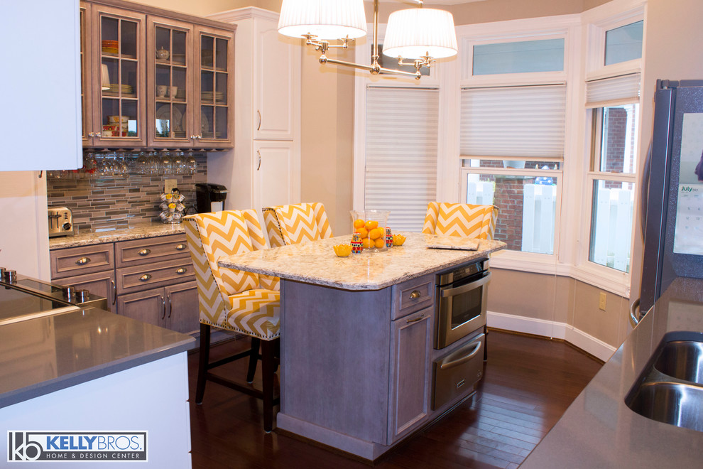 Eat-in kitchen - mid-sized transitional u-shaped dark wood floor eat-in kitchen idea in Cincinnati with an undermount sink, flat-panel cabinets, gray cabinets, quartz countertops, gray backsplash, glass tile backsplash, stainless steel appliances and an island