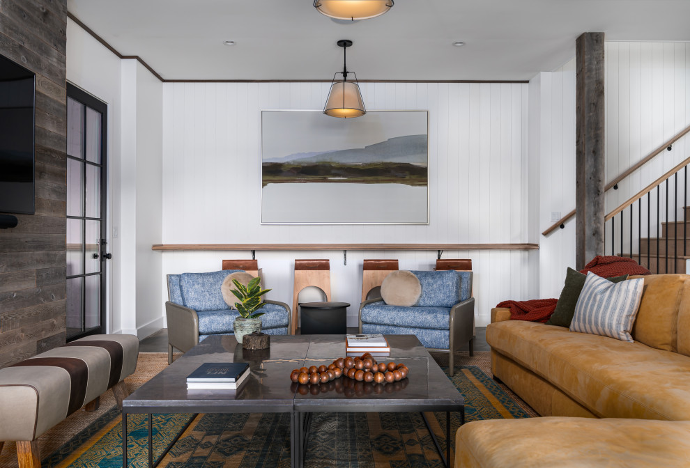 This is an example of a contemporary living room in Atlanta with white walls, dark hardwood flooring, a wall mounted tv, brown floors and tongue and groove walls.
