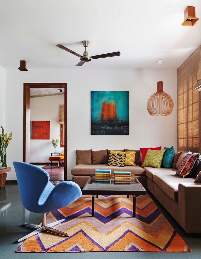 Design ideas for a contemporary enclosed family room in Bengaluru with white walls and no tv.