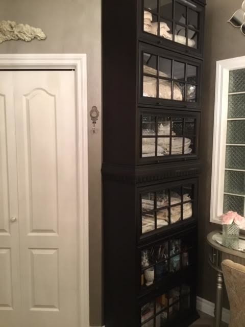 Photo of a mid-sized traditional master bathroom in Calgary with furniture-like cabinets, beige cabinets, a corner shower, a two-piece toilet, beige tile, gray tile, white tile, mosaic tile, brown walls, porcelain floors, an undermount sink, granite benchtops, brown floor, a hinged shower door and black benchtops.