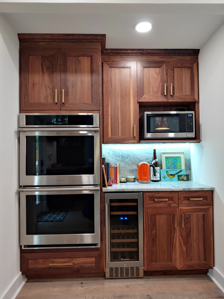 Photo of a large arts and crafts l-shaped eat-in kitchen in Tampa with recessed-panel cabinets and with island.