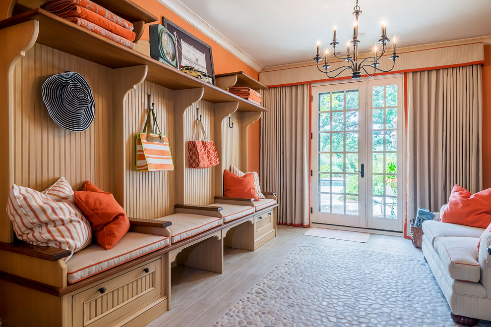 This is an example of a mid-sized traditional walk-out basement in Other with orange walls and light hardwood floors.