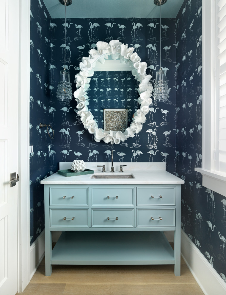 Design ideas for a small classic cloakroom in Charleston with beaded cabinets, blue cabinets, grey tiles, grey walls, light hardwood flooring, a submerged sink, marble worktops, beige floors, white worktops, a floating vanity unit, a wallpapered ceiling and wallpapered walls.