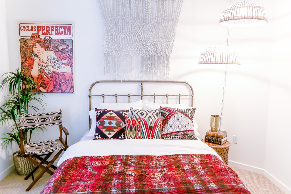 Eclectic guest bedroom in Los Angeles with white walls, carpet and beige floor.