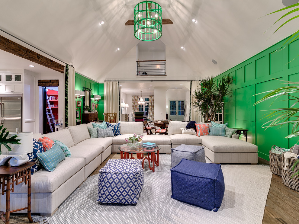 Inspiration for a beach style living room in Oklahoma City with green walls and light hardwood floors.