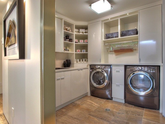 Inspiration for a mid-sized modern l-shaped dedicated laundry room in Other with flat-panel cabinets, white cabinets, quartz benchtops, white walls, marble floors, a side-by-side washer and dryer and a drop-in sink.