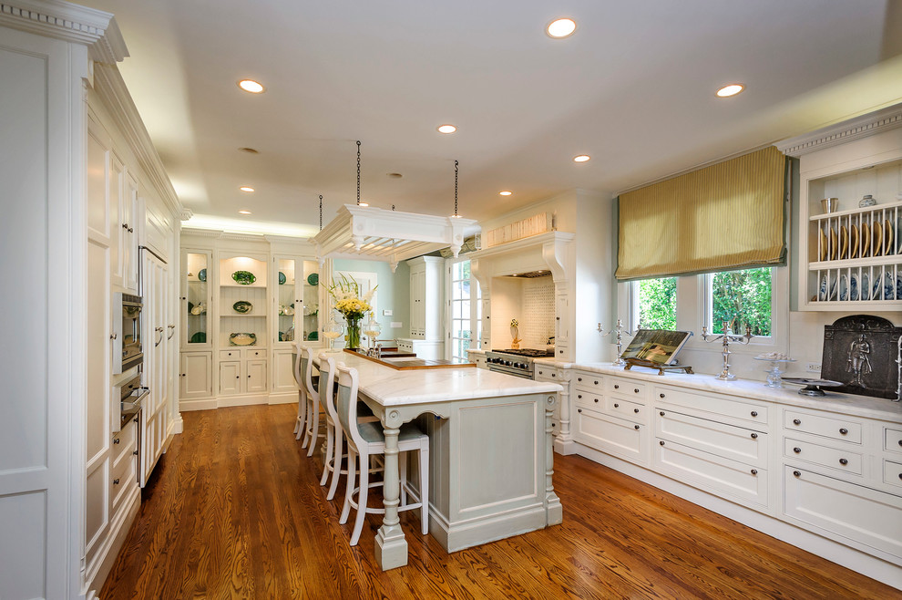 Photo of a traditional u-shaped separate kitchen in San Francisco with recessed-panel cabinets and white cabinets.